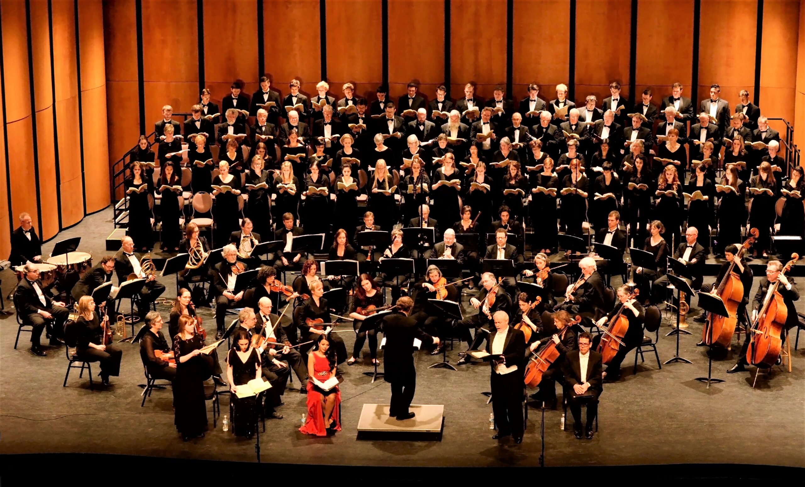 colour photo of GCC on stage with a chamber orchestra