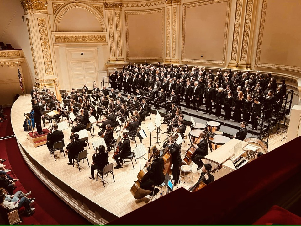 colour photo of GCC as part of a large choir on stage at Carnegie Hall in New York
